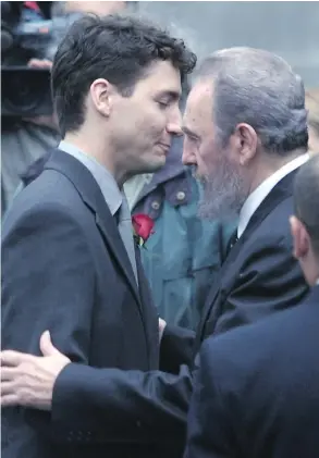  ?? PIERRE OBENDRAUF / THE GAZETTE ?? Justin Trudeau is hugged by then Cuban president Fidel Castro at the state funeral for his father, Pierre Trudeau, at Montreal’s Notre-Dame Basilica on Oct. 3, 2000.