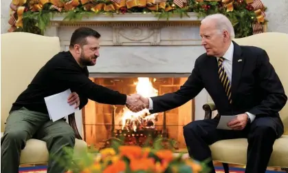  ?? Evan Vucci/AP ?? Joe Biden shakes hands with the Ukrainian president, Volodymyr Zelenskiy, at the White House in Washington on 12 December. Photograph: