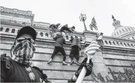  ?? New York Times file photo ?? Protesters scale a wall of the U.S. Capitol in Washington on Jan. 6. An FBI informant at the melee provided an inside glimpse of the action, records show.
