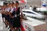  ?? KUANG LINGHUA / CHINA DAILY ?? Railway crew in front of a model of CRH380A at CRRC’s booth at an expo in Beijing in June.