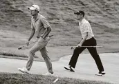  ??  ?? Collin Morikawa, left, and Justin Thomas approach the 18th green Saturday in Dublin, Ohio.