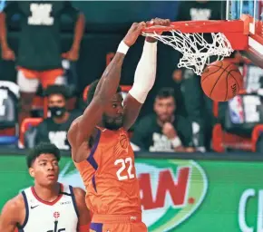  ?? KIM KLEMENT/POOL PHOTO VIA AP ?? Suns center Deandre Ayton (22) dunks the ball as Wizards forward Rui Hachimura looks on during the second half Friday.