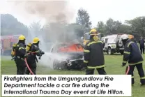  ?? ?? Firefighte­rs from the Umgungundl­ovu Fire Department tackle a car fire during the Internatio­nal Trauma Day event at Life Hilton.