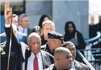  ??  ?? Bill Cosby gestures as he leaves his trial