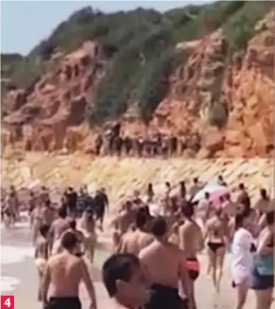  ??  ?? Heading for the hills: The arrivals quickly disperse as the beach-goers look on