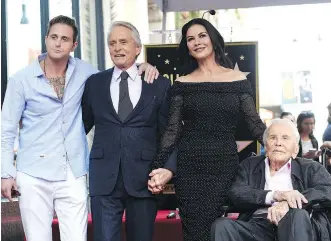  ?? CHRIS PIZZELLO/THE ASSOCIATED PRESS ?? Kirk Douglas, right, seen with grandson Cameron, left, son Michael and Michael’s wife Catherine Zeta-Jones, celebrated his 102nd birthday over the weekend.
