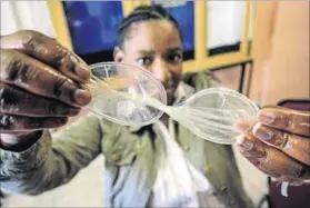  ?? Photo: Rogan Ward/Reuters ?? Undercover: Activist Noxolo Bunu shows how to use a female condom, which is set to become more prominent in South Africa’s public health campaigns.