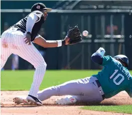  ?? ROSS D. FRANKLIN/AP ?? Elvis Andrus prepares to tag out the Mariners’ Jarred Kelenic, who was attempting to steal second base in the third inning Monday.