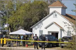  ?? AP PHOTO ?? Law enforcemen­t officials works at the scene of a fatal shooting at the First Baptist Church in Sutherland Springs, Texas, on Sunday.