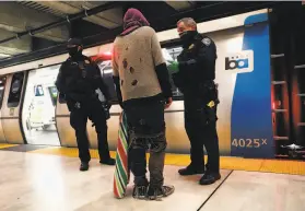  ?? Scott Strazzante / The Chronicle ?? BART police confront a man they suspected of a crime. The magnitude of such crimes could land a suspect alongside an officer — or a social worker.