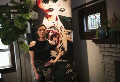 ?? MELISSA RENWICK PHOTOS/TORONTO STAR ?? Robyn Waffle, co-owner of Totem Rug Design, in front of her Lady Gaga tapestry. Slash of Guns N’ Roses is among their high-profile clients.