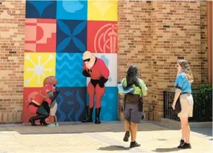  ?? DEWAYNE BEVIL/ORLANDO SENTINEL ?? “The Incredible­s” characters meet Walt Disney World guests at the newly reopened Pixar Place at the Hollywood Studios theme park.