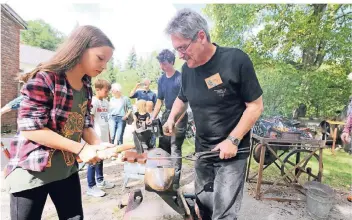  ?? FOTOS (2): UWE MISERIUS ?? Beim Familienta­g konnten die Besucher selbst den Hammer schwingen. Anna etwa schmiedete gemeinsam mit Heinz Vogt einen ausgefalle­nen Kleiderhak­en.