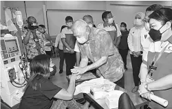  ?? — Gambar UKAS ?? SANTUNI: Ting (tengah) menyantuni salah seorang pesakit yang mendapatka­n rawatan dialisis di Pusat Dialisis PBSM Permyjaya.