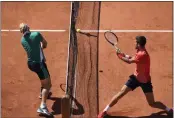  ?? CHRISTOPHE ENA — THE ASSOCIATED PRESS ?? Novak Djokovic, right, plays a shot against Alejandro Davidovich Fokina during their third-round match of the French Open at the Roland Garros stadium in Paris on Friday.