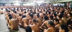  ?? PDEA/AFP ?? Naked inmates at the Cebu city jail sit during a raid by the PDEA and the Cebu provincial police office on illegal drugs and contraband on Tuesday.