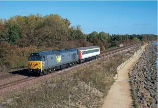  ?? ANDY MASON ?? Above: Hanson and Hall ‘Hoover’ No. 50008 Thunderer had an easy job on October 13 when tasked with hauling Mk.3 coach No. 11093 on a turning move (to match the rest of its charter set) from the sidings at Gascoigne Wood to Hull and back, the turn being achieved by traversing the Hull High Level Goods Line via Hessle Road, Walton Street Junction and the Anlaby curve. The working is seen heading back to Gascoigne Wood along the banks of the Humber near Hessle.