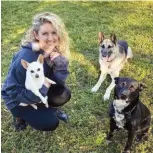  ?? ?? Vader, the black and white dog at right, adopted through Nashville Metro Animal Care and Control, happily poses with his new family.