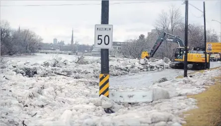  ?? DAVID BEBEE WATERLOO REGION RECORD ?? Crews work to clear chunks of ice left on Highway 24 in Galt after an ice jam on the Grand River collapsed early Wednesday morning.