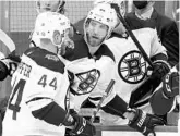  ?? KEITH SRAKOCIC/AP ?? Bruins defenseman Jarred Tinordi, right, is helped off the ice by teammate Steve Kampfer after taking a hit from the Penguins’ Brandon Tanev last week.