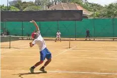  ?? Courtesy: Hichem Bramly ?? Malaysia’s Ahmad Dedat Abdul Razak serves to Omar Bahroozian of the UAE during their singles match at the Sri Lanka Tennis Associatio­n courts yesterday.