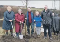  ??  ?? DIGGING DEEP: Woodland Trust CEO Beccy Speight, left, lends a helping hand at the tree planting on hills above Bolton yesterday.