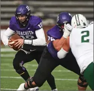  ?? (Arkansas Democrat-Gazette/Staci Vandagriff) ?? Ouachita Baptist quarterbac­k Riley Harms (left) gets a block from offensive lineman Zacary Henson during the first half Saturday against Northwest Missouri State at Cliff Harris Stadium. Harms threw for 240 yards and a touchdown in a 47-17 loss for the Tigers. More photos at arkansason­line.com/1120oubnwm/.