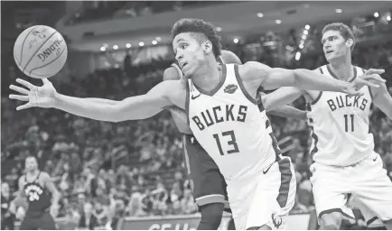  ?? BENNY SIEU/USA TODAY SPORTS ?? Guard Malcolm Brogdon (13) is averaging 13 points for the Bucks, the NBA’s only unbeaten team.