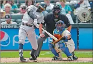  ?? TED S. WARREN/AP PHOTO ?? Didi Gregorius of the Yankees, left, hits a solo home run as Mariners catcher Carlos Ruiz, right, and home plate umpire Tom Woodring, center, look on in the fourth inning of Sunday’s game at Seattle. Gregorius homered twice and the Yankees won 6-4.