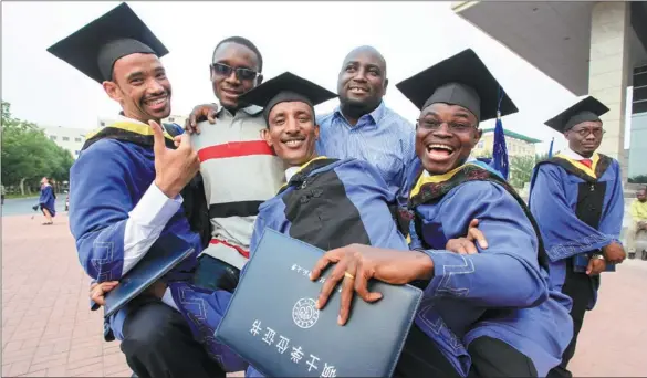 ?? LI XIANG / XINHUA ?? African students celebrate their graduation at Tianjin University of Technology and Education. More than 130 African students have graduated from the university since 2006.