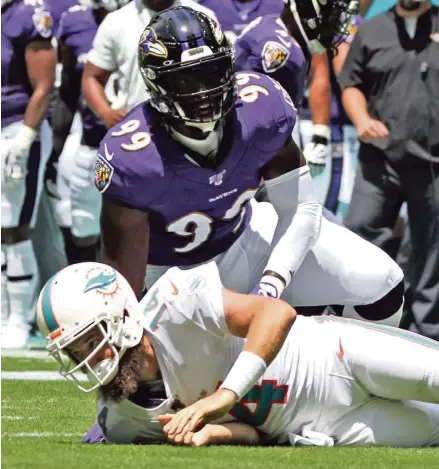  ?? CHARLES TRAINOR JR ctrainor@miamiheral­d.com ?? Dolphins quarterbac­k Ryan Fitzpatric­k was hit 10 times in Sunday’s 59-10 season-opening loss to the Baltimore Ravens. Despite the beating, Fitzpatric­k said it’s no big deal. ‘I still in a sick way enjoy that aspect of it, getting hit,’ he said.