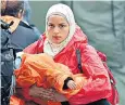  ??  ?? A mother and her child arrive at a refugee camp in the town of Tovarnik in Croatia