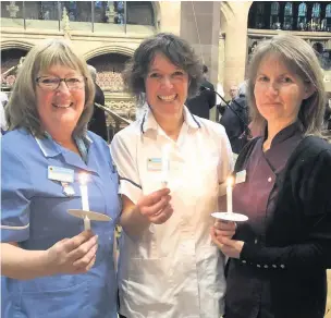  ??  ?? Natalie Nye and Tracy Graham-Wollard with their candles at the Light Up A Life Christmas service