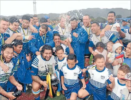  ??  ?? Champagne time: Norths skipper Henry Smith is all smiles as the champagne flies after the presentati­on of the Hardham Cup.