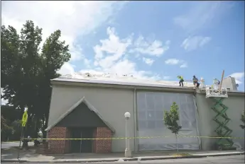  ?? NEWS-SENTINEL PHOTOGRAPH­S BY BEA AHBECK ?? Workers with Brazos Roofing put on the underlayme­nt for the new roof at Joseph Serna Jr. Charter School in Lodi on Friday.