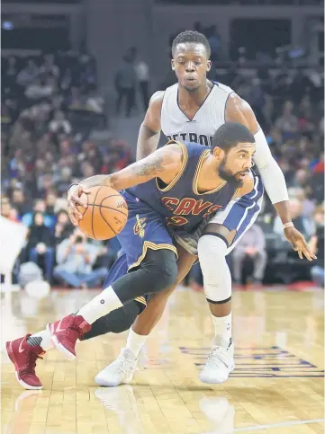  ??  ?? Cleveland Cavaliers guard Kyrie Irving (left) drives to the basket first half as Detroit Pistons guard Reggie Jackson defends at The Palace of Auburn Hills. — USA TODAY Sports photo