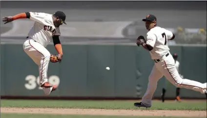  ??  ?? A single by Chicago Cubs’ Robel Garcia falls between San Francisco Giants’ Pablo Sandoval, left, and Donovan Solano (7) during the sixth inning of a baseball game in San Francisco, on Wednesday. AP PHOTO/JEFF CHIU