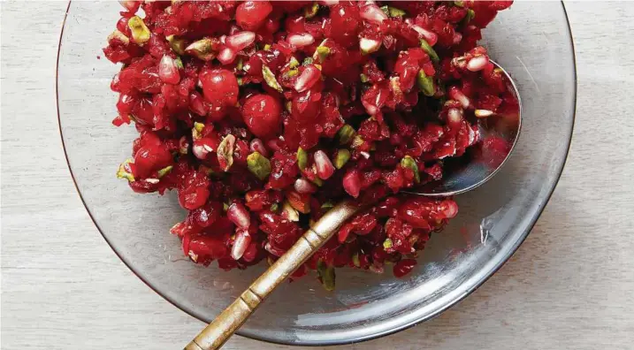  ?? Christophe­r Testani / New York Times ?? Cranberry-pomegranat­e relish provides a crimson pop of acidity and a crunch to match the turkey, and as a leftover it’s great for spooning over yogurt.