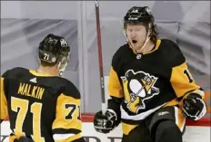  ?? Associated Press ?? Jared McCann, right, celebrates his tie-breaking goal in the third period Saturday against the Flyers at PPG Paints Arena.