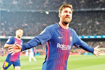  ?? Photo — AFP ?? Barcelona's Argentinia­n forward Lionel Messi celebrates after scoring a goal during the Spanish ‘Copa del Rey' (King's cup) quarter-final second leg football match between FC Barcelona and RCD Espanyol at the Camp Nou stadium in Barcelona on January...