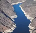  ?? MARK HENLE/THE REPUBLIC ?? A high-water mark is visible in 2019 on the shoreline of Lake Mead, which has declined dramatical­ly since 2000.