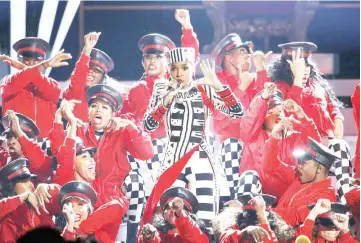  ?? — Reuters photos ?? Janelle Monae performs at the 2018 BET Awards - Show and Snoop Dogg (left) performs with host Jamie Foxx at the end of the show.