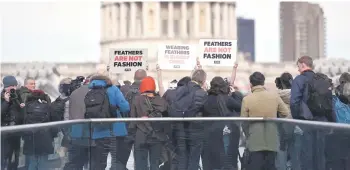  ?? — AFP photo ?? Members of animal rights group PETA hold placards during a protest in London against the use of feathers at London Fashion Week.