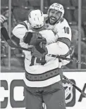  ?? VINCENT CARCHIETTA/USA TODAY SPORTS ?? Hurricanes defenseman Jaccob Slavin and center Vincent Trocheck (16) celebrate their win over the Devils.