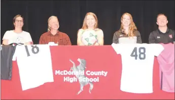  ?? RICK PECK/SPECIAL TO MCDONALD COUNTY PRESS ?? Ava Smith (center), a senior defender on the McDonald County High School soccer team recently signed a letter of intent with NEO A&M Junior College in Miami, Okla. From left to right (Kristi Smith (Mom), Jamey Smith (Dad), Ava Smith, Emily Sumler (MCHS assistant coach) and John DelaTorre (MCHS coach).