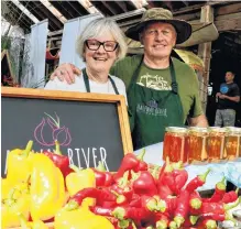  ?? ?? Halfway River Farms’ owners Greg Pace and Elsie Wetmore offered fresh produce alongside bottled honey that comes from Hantsport.