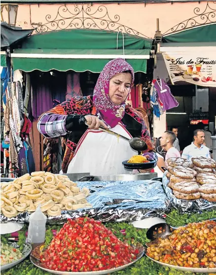  ?? Pictures: GALLO IMAGES/ALAMY ?? SOMETHING DISHY: Plates are piled high at the Night Market in the Djemaa el-Fna, Marrakesh's main square