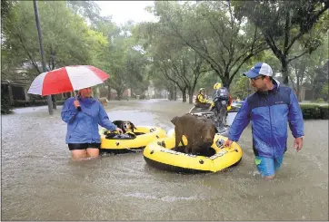  ?? GODOFREDO A. VASQUEZ/HOUSTON CHRONICLE VIA ASSOCIATED PRESS ?? Residents and pets are evacuated Monday from their homes as floodwater­s from Tropical Storm Harvey rise in Houston, whose metro area covers about 10,000square miles, an area slightly bigger than New Jersey.