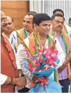  ?? ?? IN NEW DELHI on July 11, 2019, BJP working president J.P. Nadda and Goa Chief Minister Pramod Sawant welcome Congress MLAS who resigned to join the BJP.