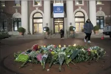  ?? MARY ALTAFFER, FILE - THE ASSOCIATED PRESS ?? In this Dec. 12, 2019file photo, a woman walks past a make-shift memorial for Tessa Majors inside the Barnard College campus in New York. Authoritie­s say a 14-yearold was arrested in fatal stabbing of Majors on Saturday, Feb. 15, 2020. Majors was stabbed as she walked through Manhattan’s Morningsid­e Park on Dec. 11.